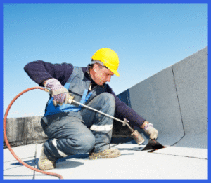 Professional roofer with hard hat on roof